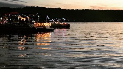 Several boats lined up on Findley Lake for the boat parade.