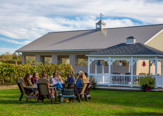 Friends tasting wine outdoors at Liberty Vineyards