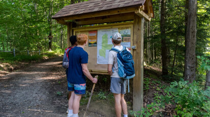 Young Men Hiking looking at trail map