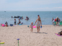 Mom and daughter walking on Sunset Bay Beach web