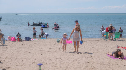 Mom and daughter walking on Sunset Bay Beach web