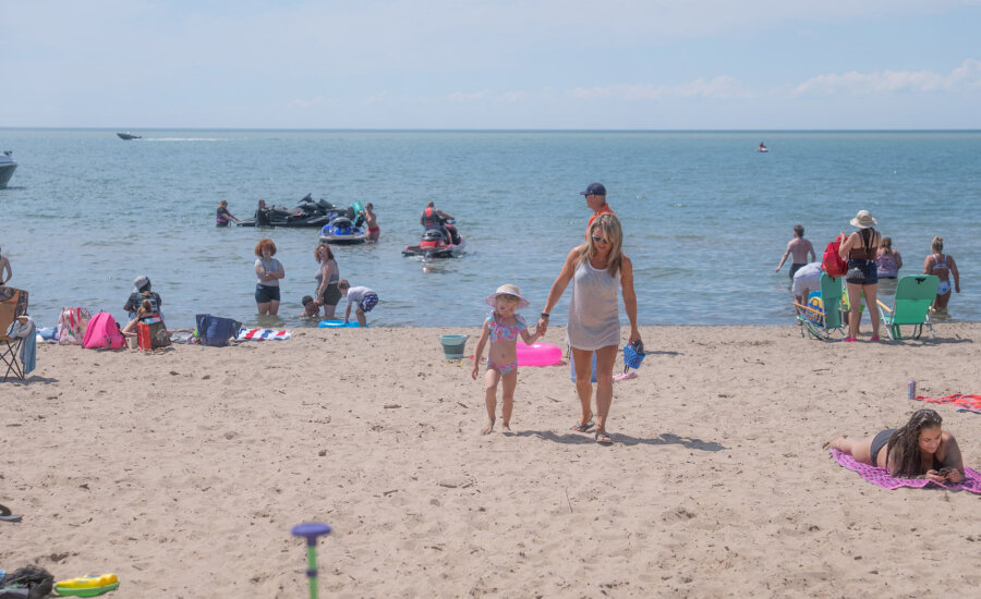 Mom and daughter walking on Sunset Bay Beach web