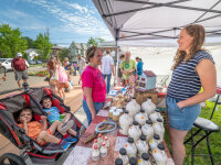 Woman and kids shopping for maple syrup at Fredonia Farmers Market web
