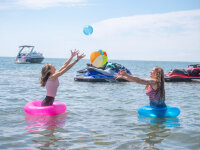Women in Lake Erie playing with beach balls web