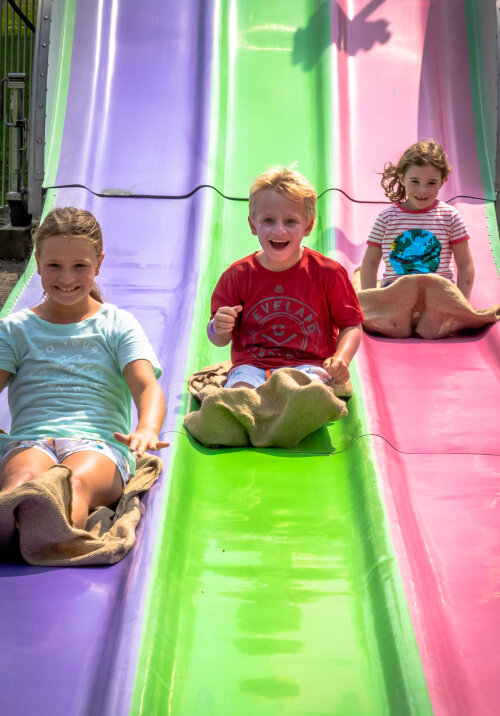 Midway kids going down fun slide