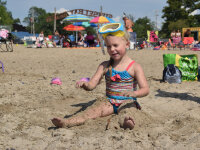 Girl playing in sand at Lake Erie beach