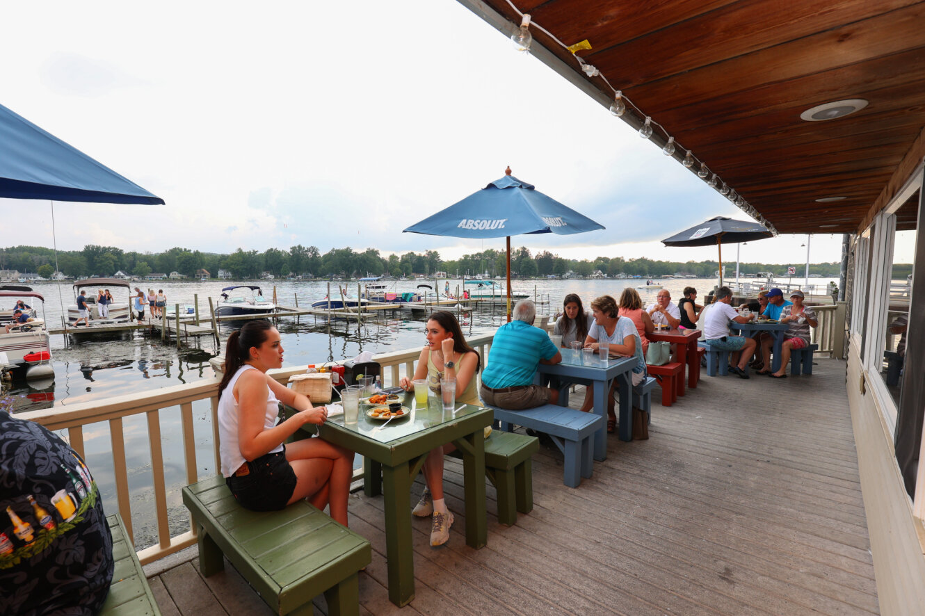 People dining outside at the Village Casino in Bemus Point